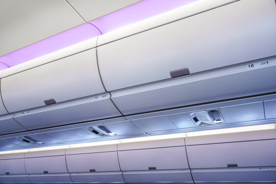 Carry-on Luggage In Overhead Storage Compartment On Commercial Airplane.