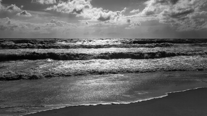 Panorama with waves on a stormy sunny summer day on the beach of Sylt island, Germany. Cloudy sky...