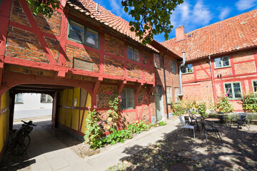 Lovely courtyard of half-timbered building of Helsa Farm in Ystad, Sweden - 695400370