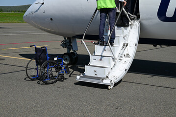 Wheelchair patients Airport, Disabled person in the interior of the airport with airplane being...