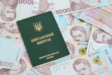 Ukrainian military ID and hryvnia bills. Payments to soldiers of the Ukrainian army, salaries to...