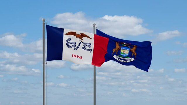 Michigan and Iowa US state flags waving together on cloudy sky, endless seamless loop