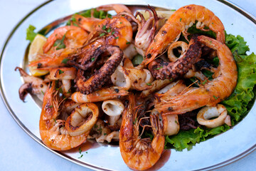 Close-up shot of the seafood photography with shrimps grilled mixed with kaffir lime leaves. 