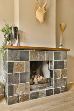 Brick fireplace with wooden mantle and fire