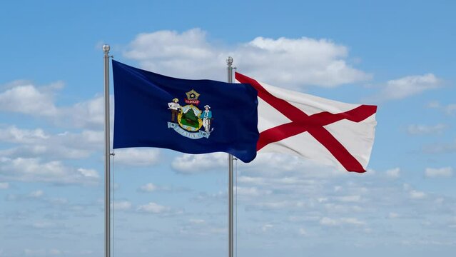 Alabama and Maine US state flags waving together on cloudy sky, endless seamless loop