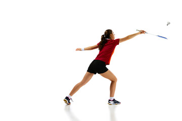 Fototapeta na wymiar Full length portrait of badminton player demonstrates her skills in attack and defense while playing badminton against white background. Concept of sport, active lifestyle, strength and power.