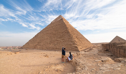 Woman tourist looking at the Great Pyramids of Egypt. Giza, Egypt