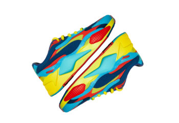 Multicolor sport shoes on yellow background with shadows