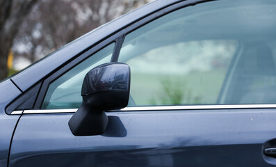 reflection in car mirror, conveying introspection and perspective in a fleeting moment of travel