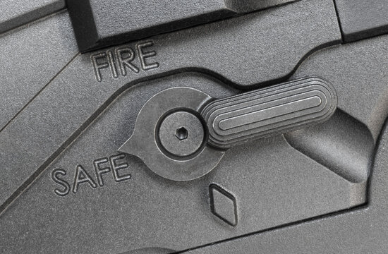 Safety switch on a modern rifle that is in the safe position to prevent it from shooting.