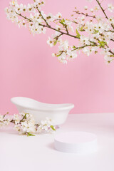 Empty podium or pedestal with spring bloom and bath. Spring mock up for cosmetic products