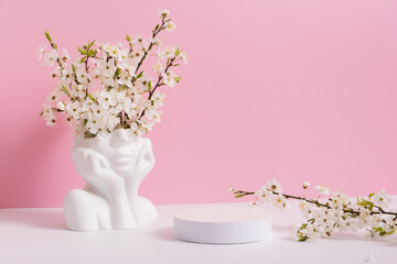 Empty podium or pedestal with spring bloom. Mock up for cosmetic products