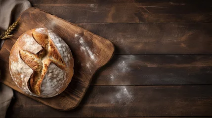 Photo sur Aluminium Boulangerie Freshly baked bread on a wooden table with flour. 