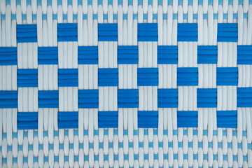 Texture of white and blue synthetic fabric. Perpendicularly woven white and blue plastic threads. Abstract multitasking background - obrazy, fototapety, plakaty