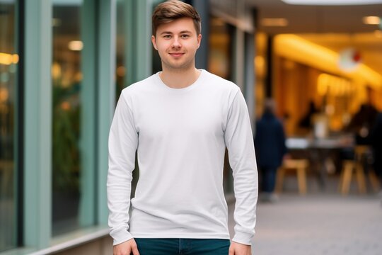 White Chic Presence: Vlogger Poses Stylishly in Front of an Upscale Clothing Store, Sporting a Classic White Long Sleeve T-Shirt in a High-Quality Mockup Image