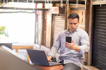 very serious man looking at his cell phone