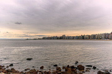 Naklejka premium Landscape view of the city of Montevideo in the area of Pocitos. Tourist place in Uruguay, sunset on a cloudy day.