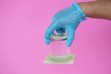 Closeup hand hold and turn a glass of water over down. covered the glass with paper. Concept, ...