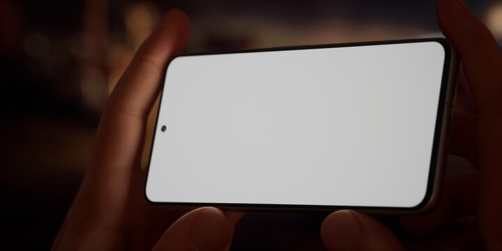 CU Caucasian male using his phone near campsite in the evening, screen mockup