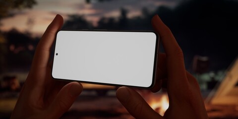 CU Caucasian male using his phone near campsite in the evening, screen mockup