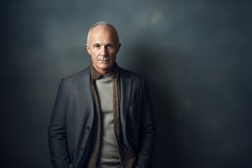 Fototapeta premium Portrait of a glad man in his 50s wearing a chic cardigan against a bare monochromatic room. AI Generation