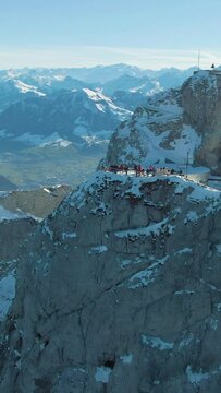 Mountain Pilatus and Lake Lucerne in Winter Morning. Tourists on Viewpoint. Swiss Alps, Switzerland. Aerial View. Drone is Orbiting. Vertical Video