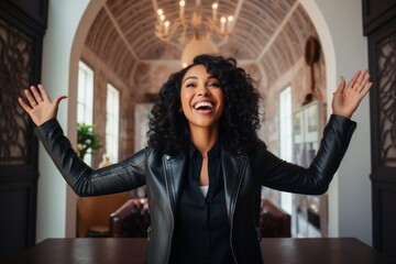 Fototapeta premium Portrait of a joyful woman in her 30s sporting a stylish leather blazer against a stylized simple home office background. AI Generation