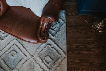 top down view of a leather chair, rug and hardwood floors