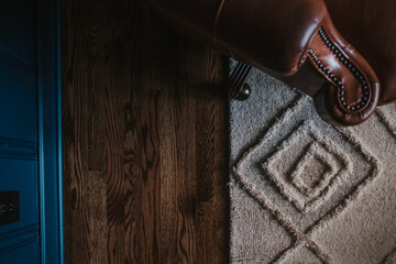 leather chair, rug and hardwood floors