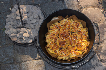 Chelsea buns baked with grill briquettes fot top heat management in the Dutch ​Oven.