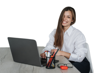 Excited caucasian brunette businesswoman in white shirt and black pants sits at desk with laptop smiles, remote works looks at camera against transparent background. Successful people. Home office