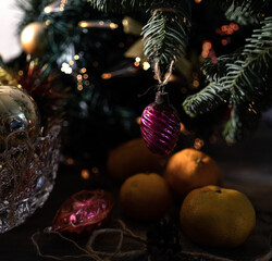 New Year's, festive background with tangerines, Christmas tree and Christmas tree decorations