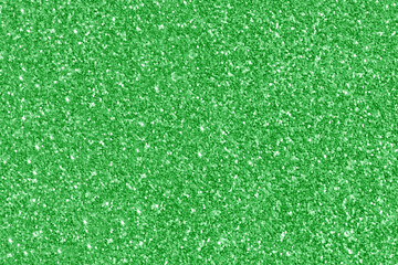 Green Glitter Christmas New Year Valentine Day Background.  Glowing Sparkle Bright Shining Bokeh Light Texture for Celebration, Anniversary and Festival backdrop. 