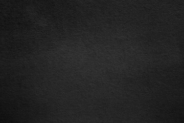 Black paper surface with grainy texture
