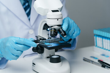 Scientists conducting research investigations in a medical laboratory. Scientist wearing medical...