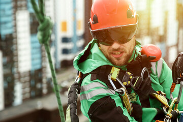 Industrial mountaineering worker during high rise work