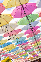 umbrellas of many colors hanging one after another
