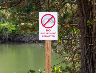 A Warning Sign Prohibiting Shellfishing in the Water