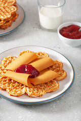 waffles with Norwegian brunost traditional brown cheese and raspberry jam