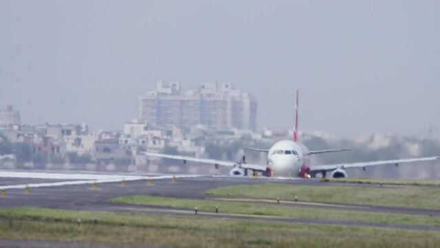 Airasia Passenger airplane retracts landing gear after a take off or a commercial flight leaving off the runway. Concept of transportation service, departure, journey, travel and tourism.