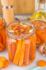 Homemade pickled carrots, Fermented carrot, salted conserved preserved vegetables canned in glass jars on kitchen table