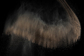 Soil explosion on black background. Abstract texture. Cloud of brown ground. Sand explode.	
