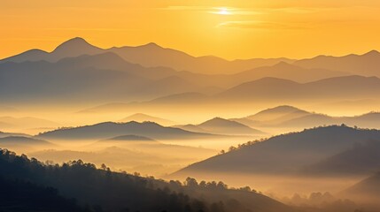 Obraz premium The sun is setting over a mountain range. Misty mountains on a sunset or dawn.