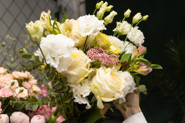 Floristry. Flowers. A florist girl collects a bouquet.