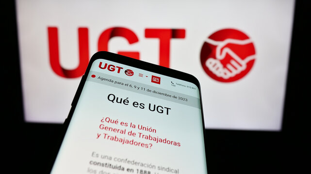 Stuttgart, Germany - 12-07-2023: Smartphone with website of Spanish Uni&oacute;n General de Trabajadores (UGT) in front of logo. Focus on top-left of phone display.