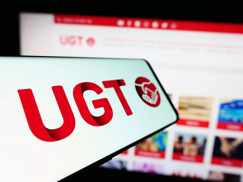 Stuttgart, Germany - 12-07-2023: Mobile phone with logo of Spanish Uni&oacute;n General de Trabajadores (UGT) in front of website. Focus on center-left of phone display.