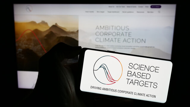 Stuttgart, Germany - 12-09-2023: Person holding cellphone with logo of organisation Science Based Targets initiative (SBTi) in front of webpage. Focus on phone display.