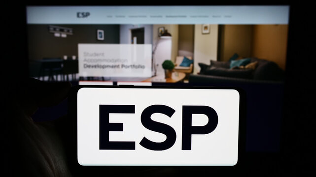 Stuttgart, Germany - 12-09-2023: Person holding cellphone with logo of British company Empiric Student Property plc (ESP) in front of business webpage. Focus on phone display.