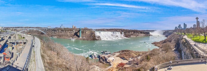 Panoramic picture over Niagara Falls with blue sky and rainbow in summer