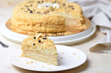 Delicious Napoleon Cake, Delicate Handmade Dessert with Custard and Puff Pastry Layers on Bright Background